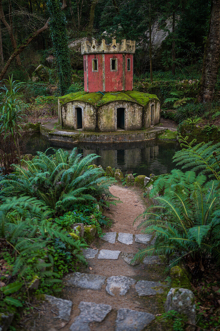 Ancient duck house resembling a tower at Valley of Lakes and Little Birds Fountain at Park and National Palace of Pena (Palacio de la Pena), Sintra, Portugal
