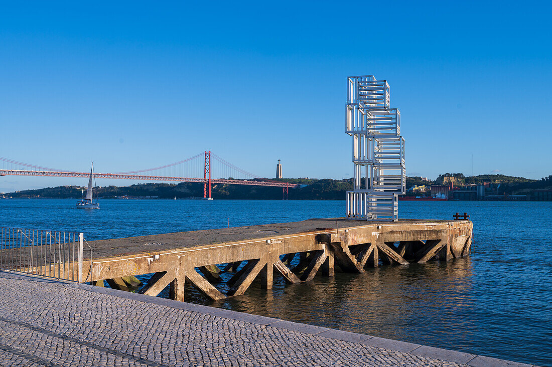 Riverside Escultura de Luz sculpture and Ponte 25 de Abril bridge by Tagus River, Belem, Lisbon, Portugal