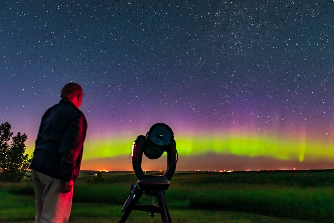 A selfie of me with the Celestron C8 telescope, with an aurora in the north, for a book illustration. Taken July 21, 2019 from the backyard on a very clear night just at moonrise.