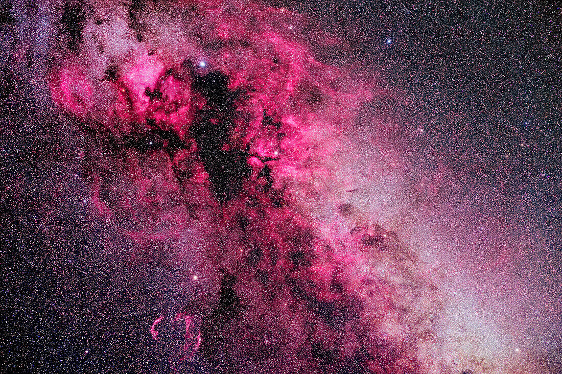 This is a framing of the rich complex of nebulosity in and around the constellation of Cygnus, in a blend of "white light" images and images shot through a deep red hydrogen-alpha filter that isolates the red emission line from the gas clouds, bringing them out in much more detail than is otherwise possible.