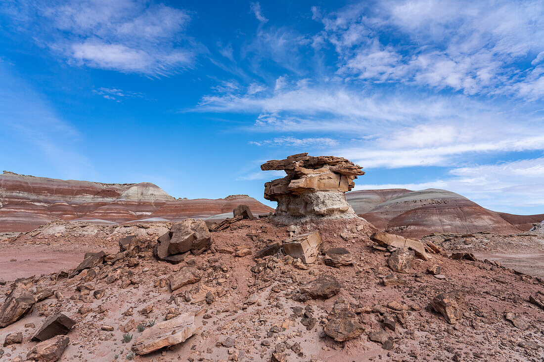 A sandstone caprock on a clay hoodoo in the bentonite hills of the Caineville Desert near Hanksville, Utah.