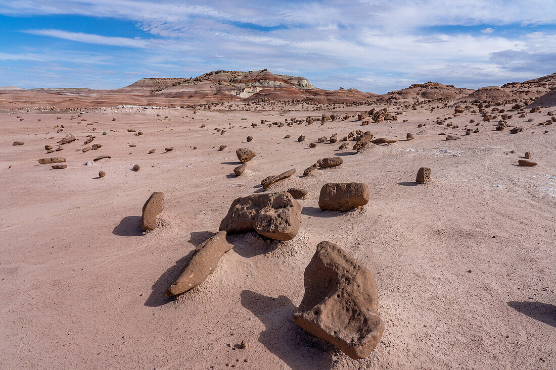 A sandstone boulder field and colorful bentonite clay hills of the Morrison Formation in the Caineville Desert near Hanksville, Utah.