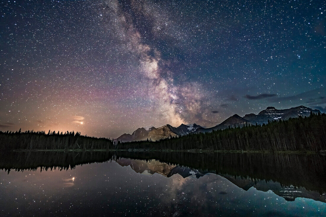 Mars (at left in clouds) and the summer Milky Way over Lake Herbert and reflected in the still waters this night. This is in Banff National Park, Alberta. I shot this July 17, 2018 on a night that gradually clouded up, after a run of two very good nights previous to this.