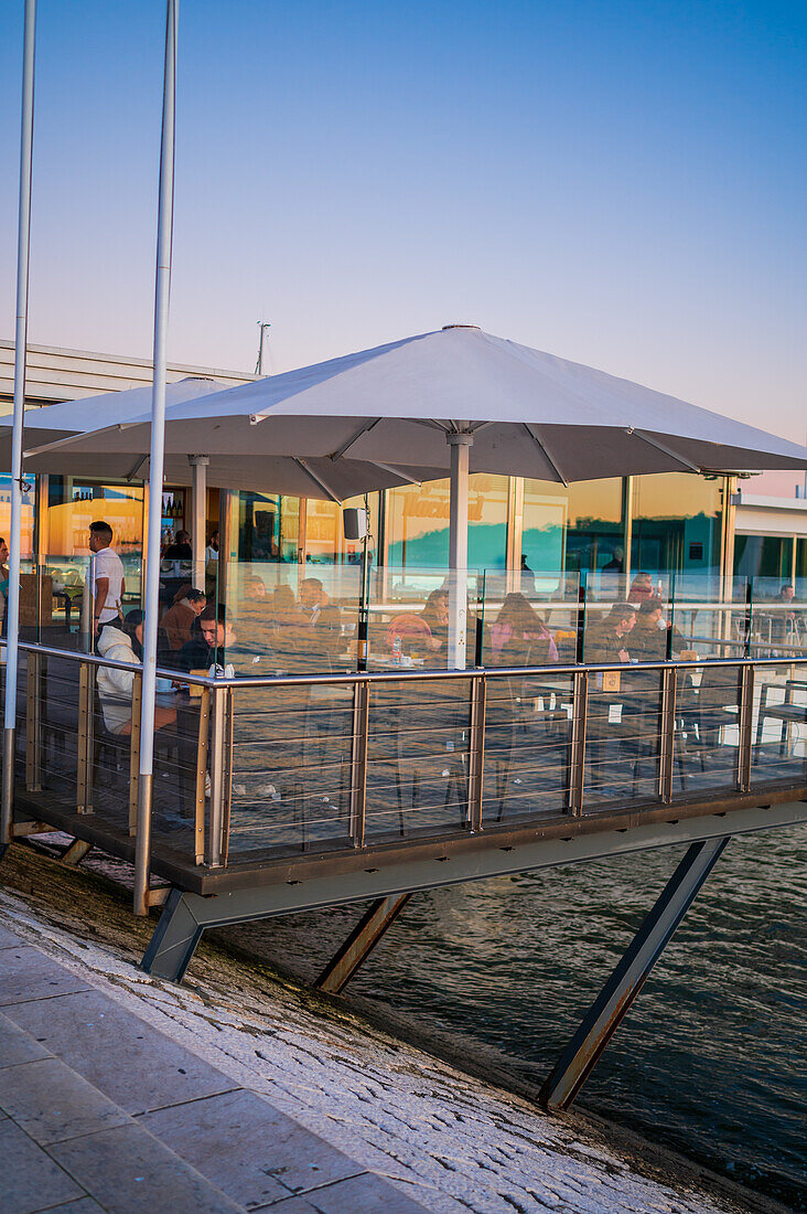 Riverside cafe Confeitaria Nacional Belem by Tagus River at sunset, Lisbon, Portugal