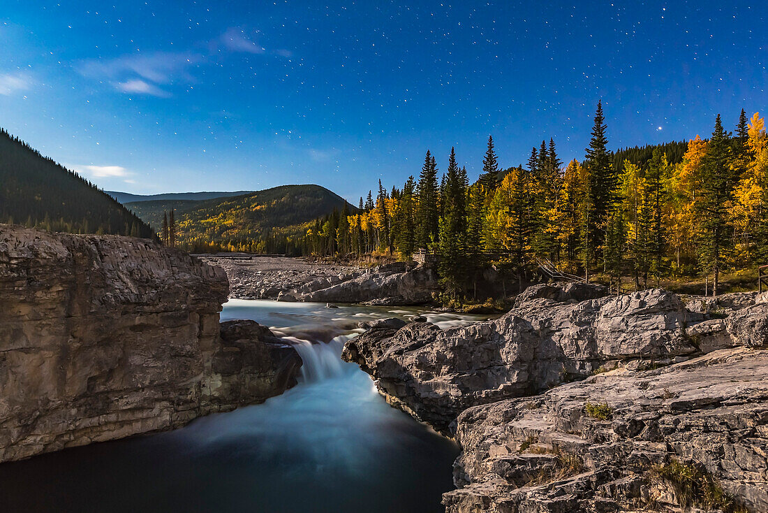 Stars over Elbow Falls in the Kananaskis area of southern Alberta, shot under the light of the gibbous Moon on the last night of summer, September 22, 2015. The aspens were in full fall foliage on a very clear, mild night.