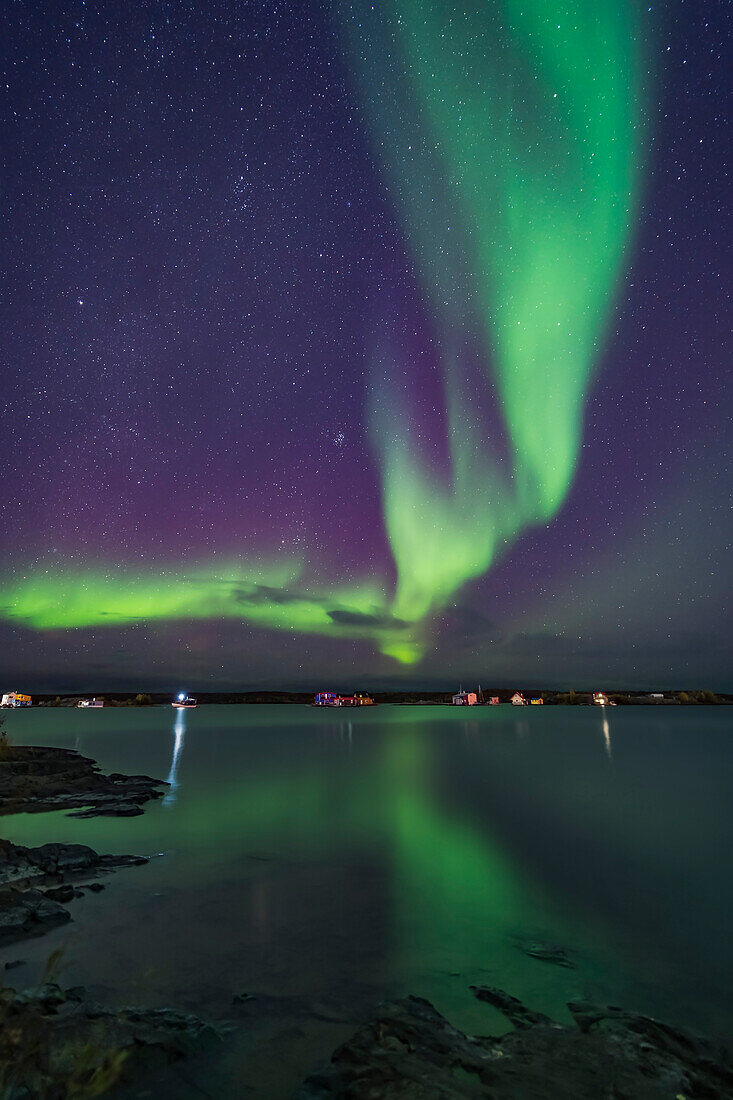 A curtain of aurora sweeps over the houseboats moored on Yellowknife Bay in Yellowknife, NWT, on September 11, 2018.