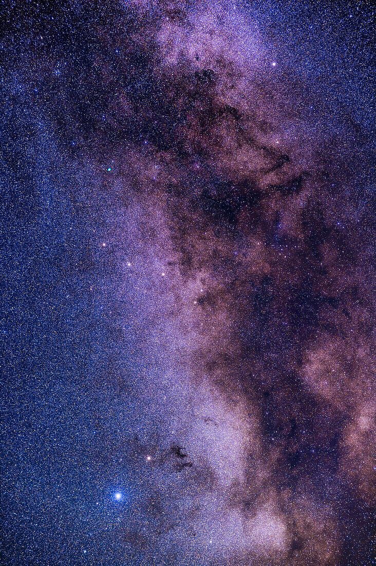 A framing of the Milky Way from Altair in Aquila at bottom up to Albireo in Cygnus at top. The prominent dark nebulas B142 and B143, aka Barnard's E, are right of yellowish Tarazed above Altair. The constellation of Sagitta the Arrow is at centre, and to the right of Sagitta in the dark dust lanes is the Coathanger asterism, aka Collinder 399. Above Sagitta is the green disk of the Dumbbell Nebula, Messier 27, in Vulpecula the Fox. Above it, at upper left is the star cluster NGC 6885. And as a bonus, one of the stars in Sagitta is actually the globular cluster Messier 71.