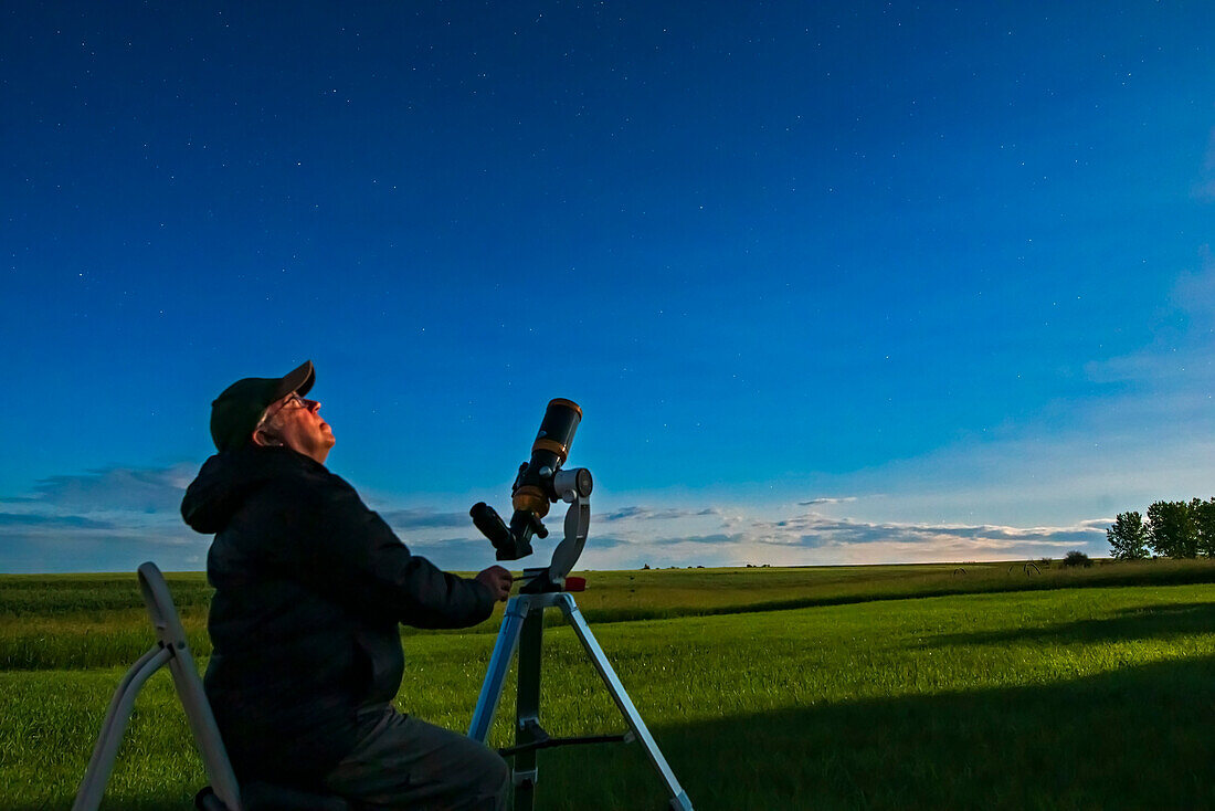 A selfie of me observing in the moonlight with the 80mm apo refractor. For use as a book illustration.