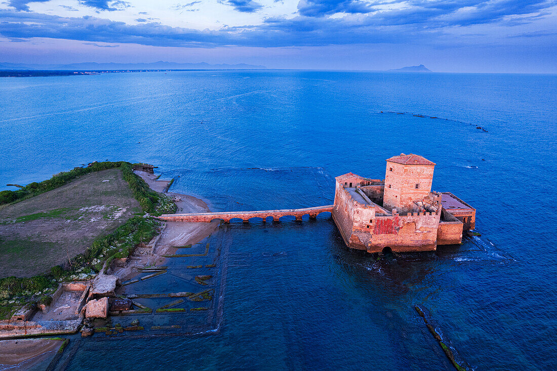 Aerial view of Torre Astura castle in the water of the Tyrrhenian Sea seen at dusk, Lazio, Italy, Europe