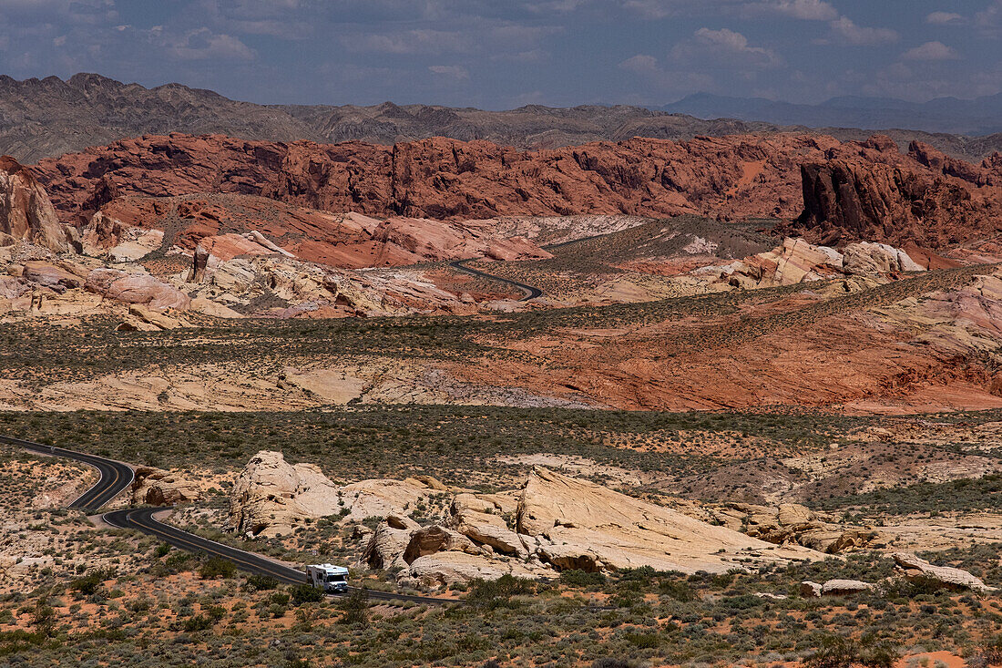 An RV Camper Van Recreational Vehicle travels the highway of White Domes Road through the Valley of Fire State Park, Nevada, United States of America, North America