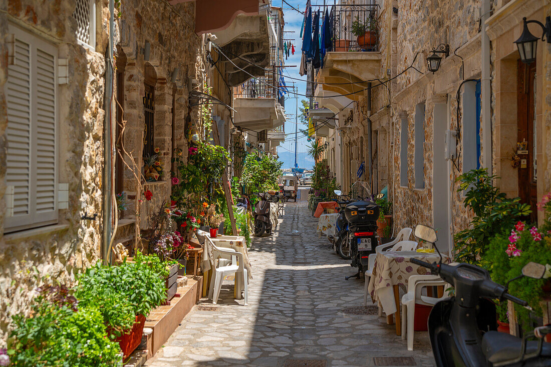 View of narrow street leading towards harbour in Kalimnos, Kalimnos, Dodecanese Islands, Greek Islands, Greece, Europe