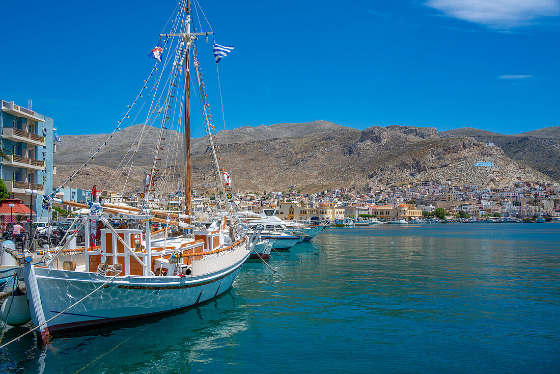 View of port and town of Kalimnos with hills in the background, Kalimnos, Dodecanese Islands, Greek Islands, Greece, Europe