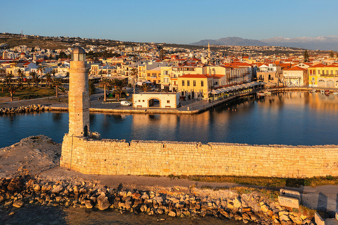 Lighthouse at the Venetian harbor with a view over, Rethymno, Crete, Greek Islands, Greece, Europe