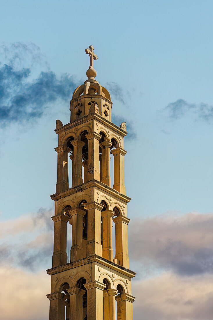 St. George Holy Orthodox Metropolitan Church bell tower and cross against a sky with clouds in Nafplion, Peloponnese, Greece, Europe