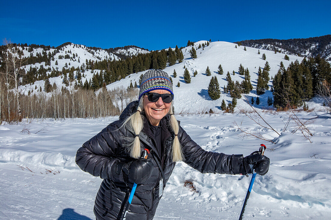 USA, Idaho, Ketchum, Senior female hiker hiking in mountains in winter