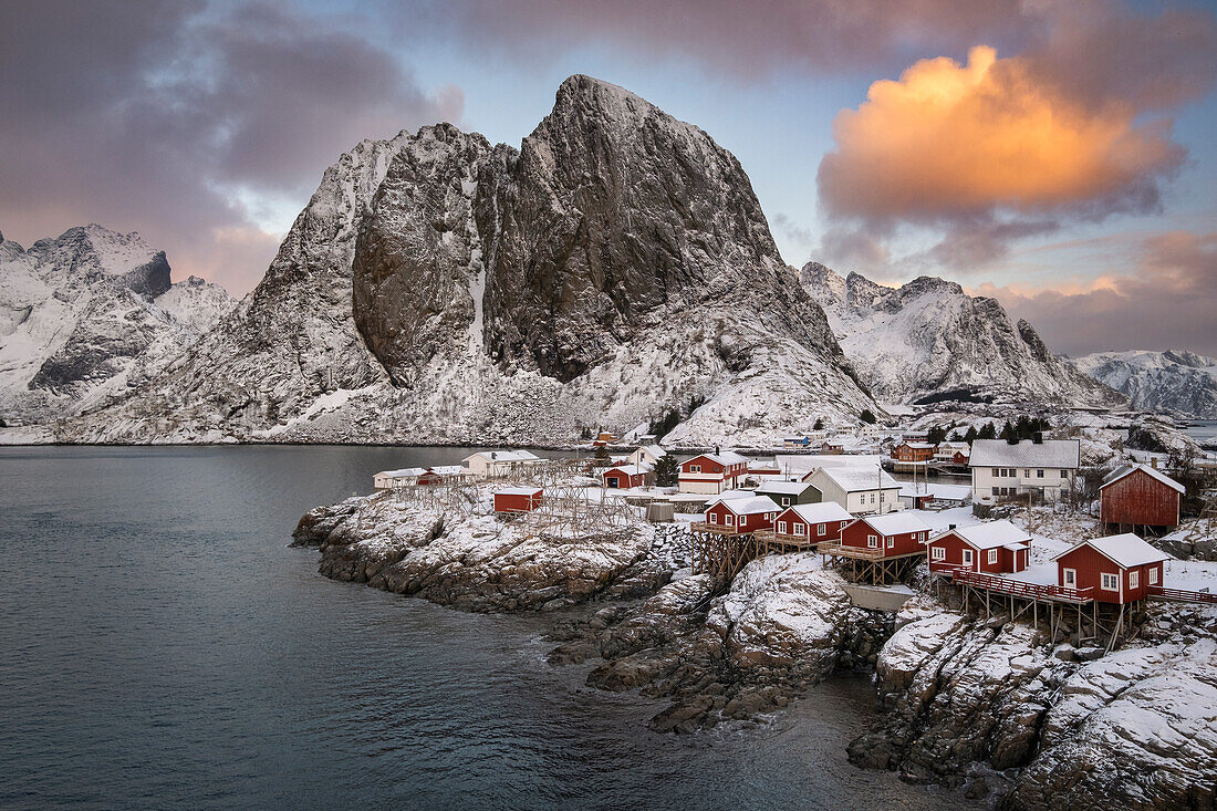 Red Norwegian Rorbuer Huts and Festhaeltinden mountain in winter, Hamnoy, Moskenes Municipality, Nordland County, Lofoten Islands, Norway, Scandinavia, Europe