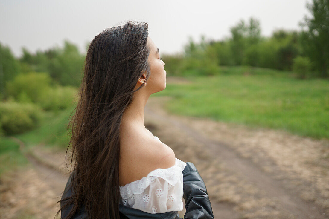 Portrait of teenage girl (16-17) standing in nature