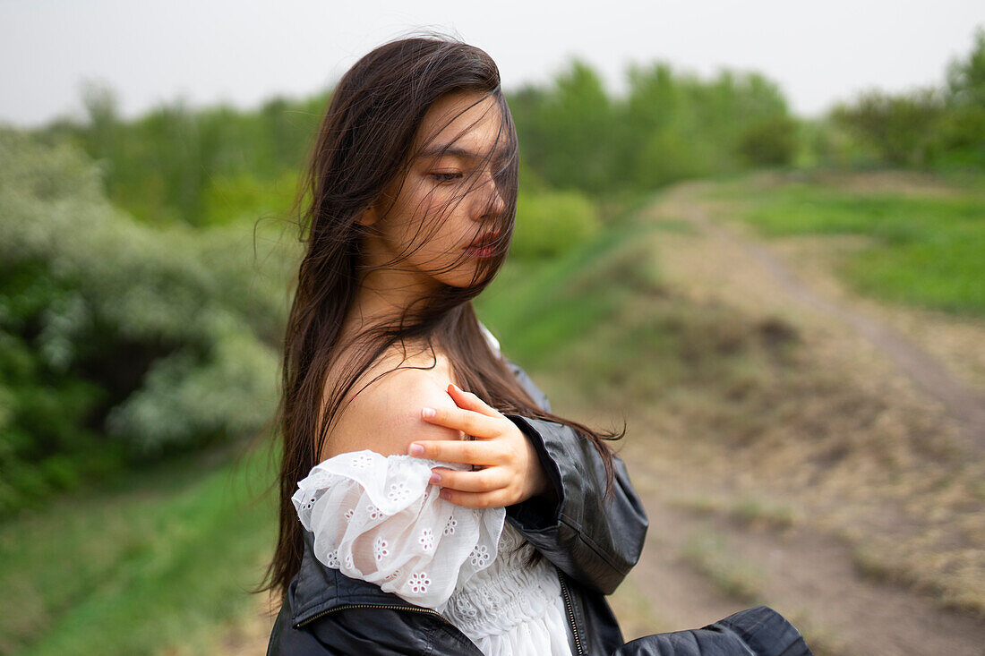 Portrait of teenage girl (16-17) standing in nature