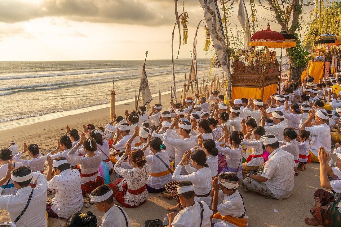 View of people at prayer on Kuta Beach for Nyepi, Balinese New Year Celebrations, Kuta, Bali, Indonesia, South East Asia, Asia