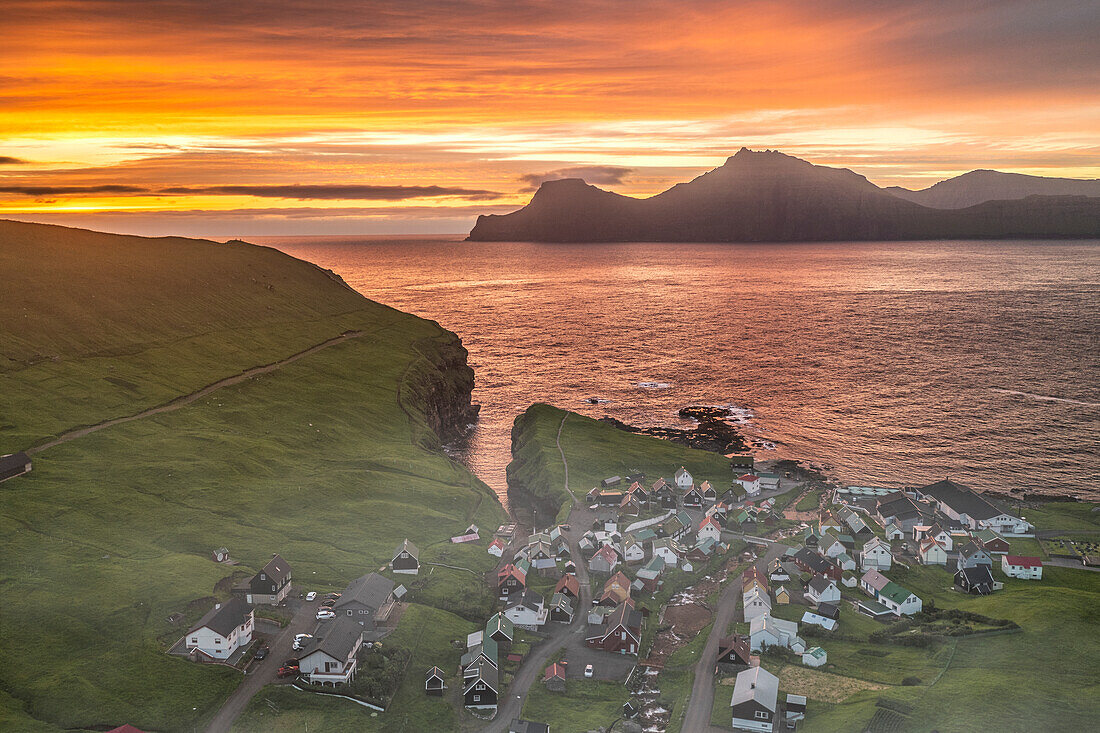 Fiery sky at dawn over Kalsoy island and the village of Gjogv, overhead view, Eysturoy Island, Faroe Islands, Denmark, Europe