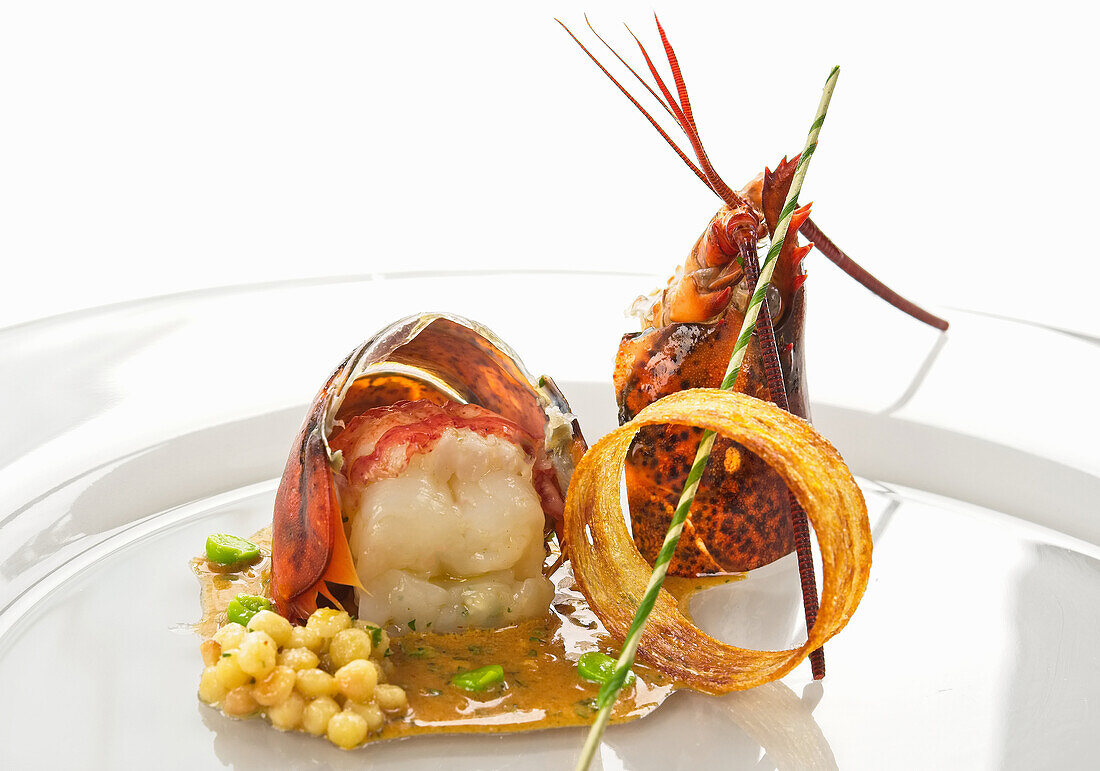 Lobster tail with wasabi sauce, chickpeas and parmesan ring