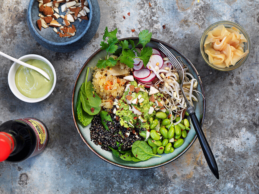 Quinioa bowl with soybeans, cilantro, almonds, mashed avocado, kimchi, and spinach