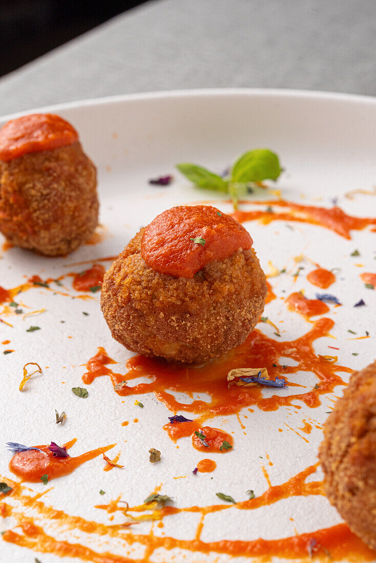 Fried meatballs with tomato sauce