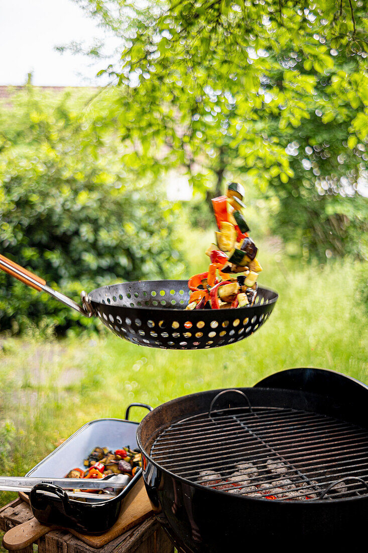 Vegetables in a pan over charcoal grill