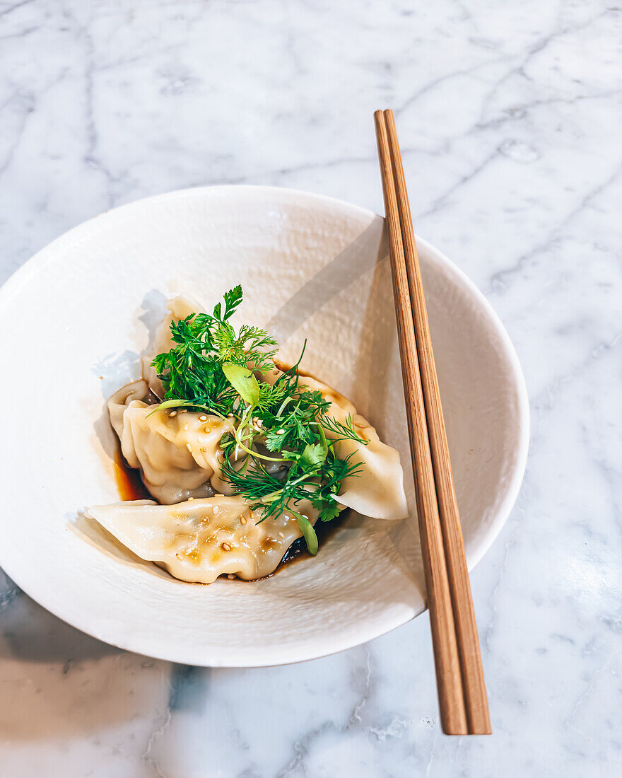 Dumplings with soy dressing and fresh herbs
