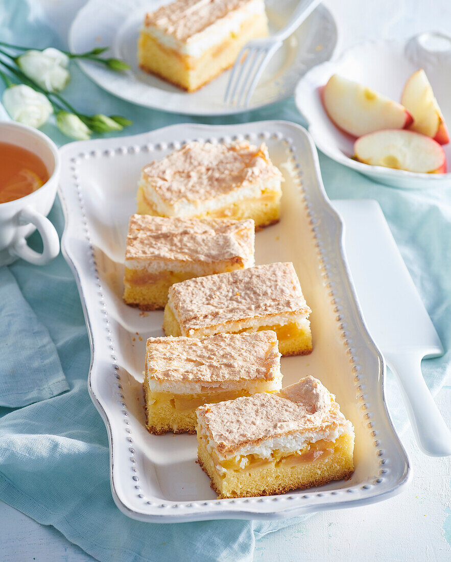 Apple cake slices with coconut meringue topping