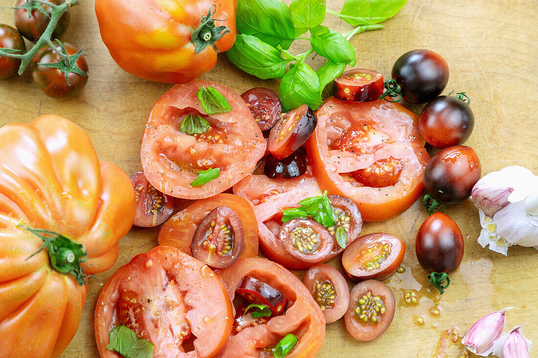 Tomatoes (ox hearts and black lady) sliced with basil and garlic