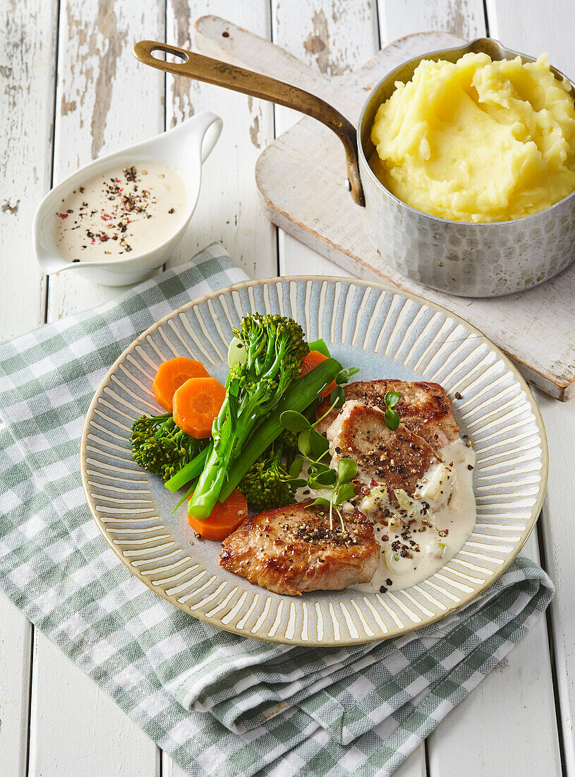 Pepper pork steaks with broccoli and mashed potatoes