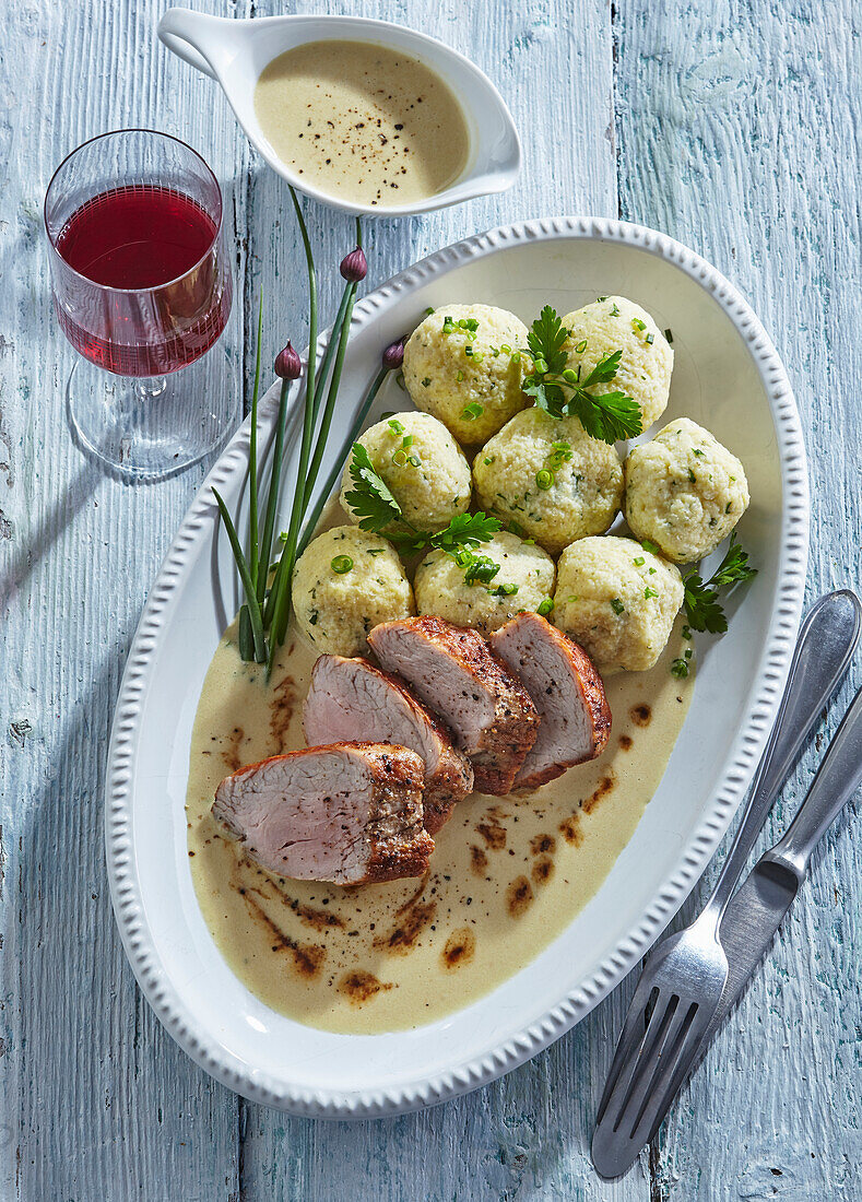 Pork tenderloin with roasted sauce and gluten-free dumplings