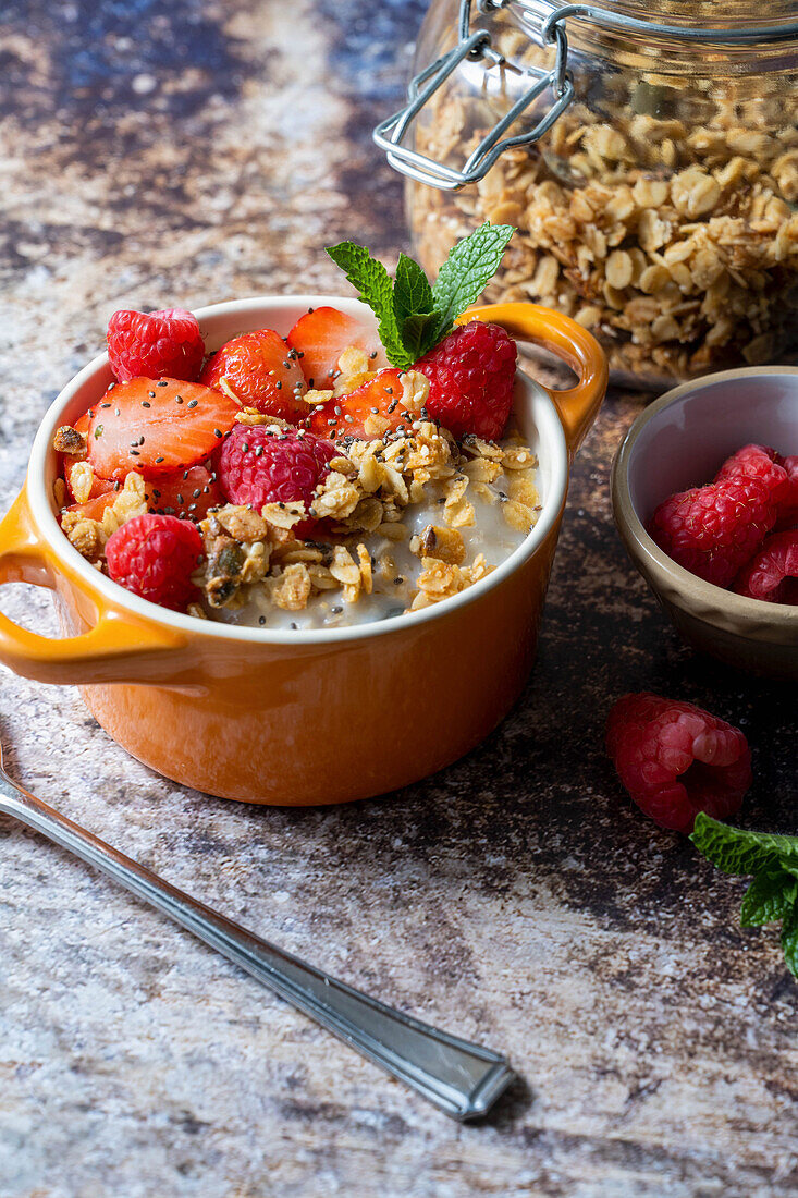 Homemade granola with milk and fresh strawberries