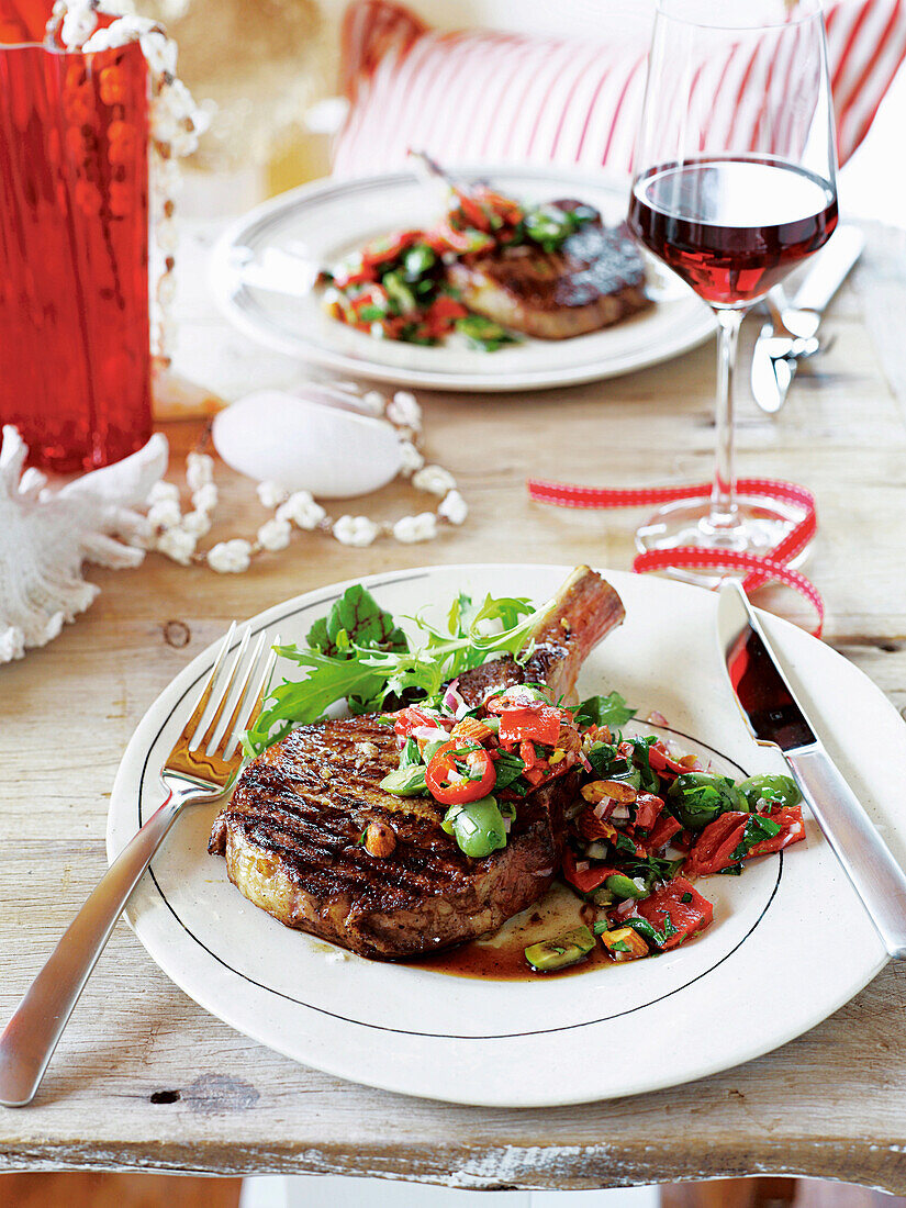 Rib steaks with roasted capsicum and almond salsa