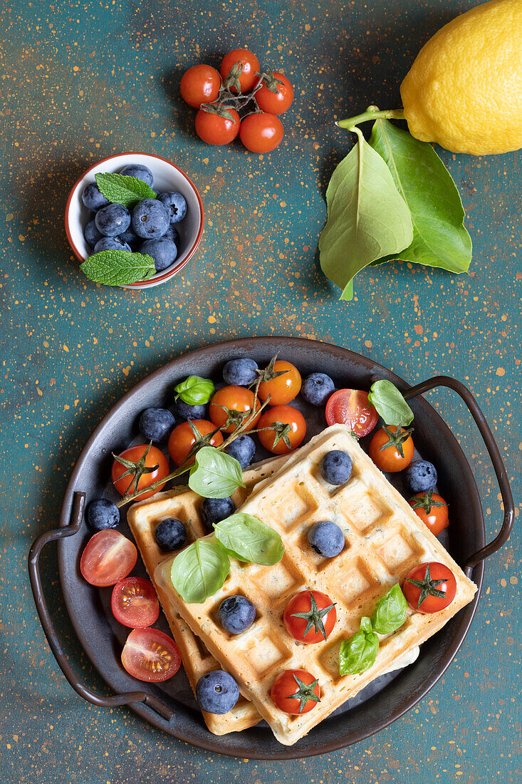Hearty parmesan waffles with tomatoes and blueberries