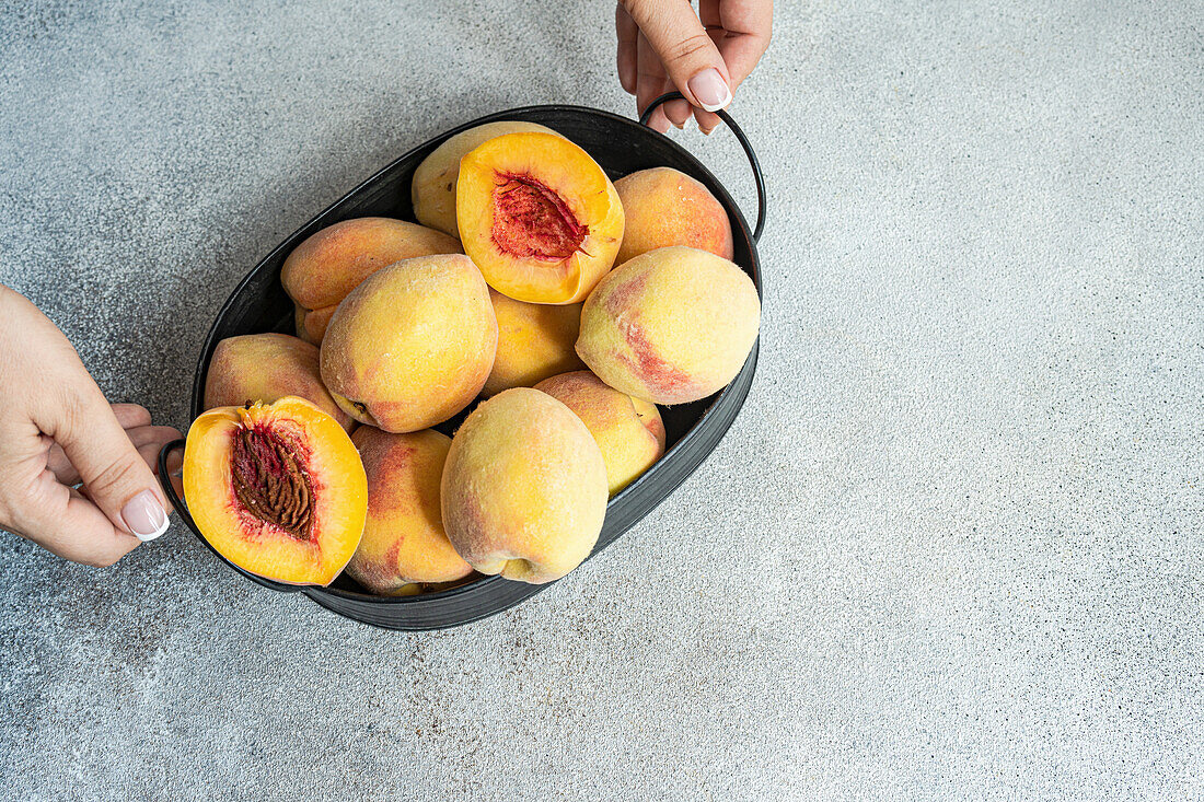 Bowl with ripe organic peaches
