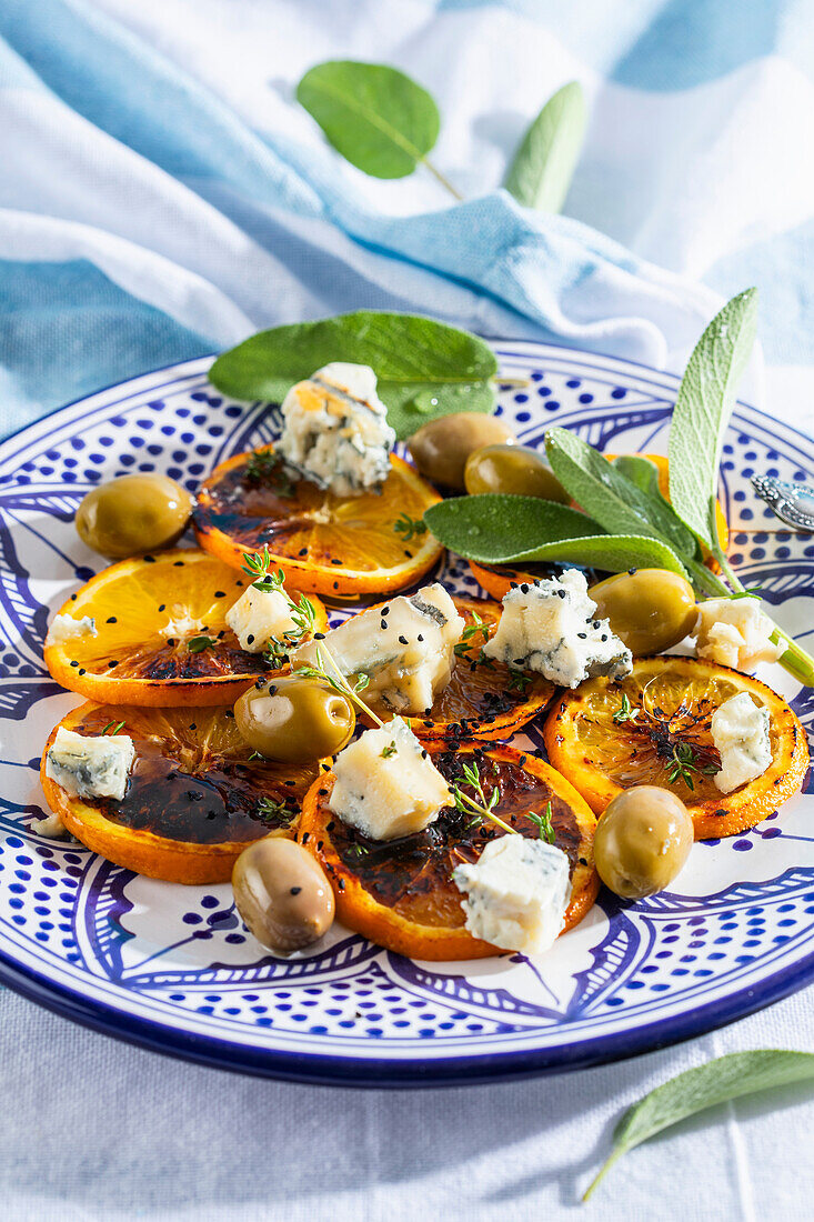 Salad with grilled orange slices, cheese and olives