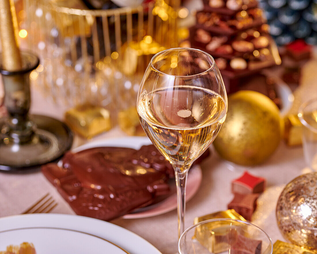 A glass of champagne on a festively decorated table