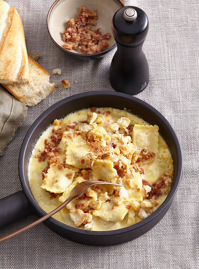 Ravioli with cream sauce and crispy bacon