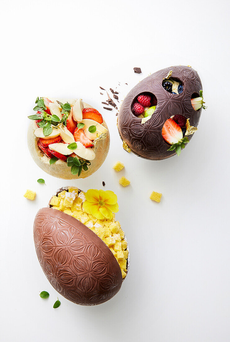 Filled chocolate eggs - with fruit and pastries, strawberries, mimosa cake
