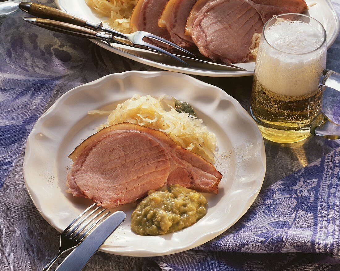 Smoked pork rib with sauerkraut & pea puree, décor: beer glass