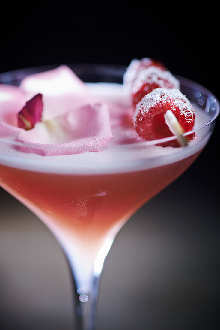Vodka-raspberry cocktail with port wine and edible flowers