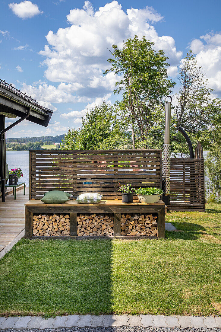 Firewood rack with bench seat, view of the lake