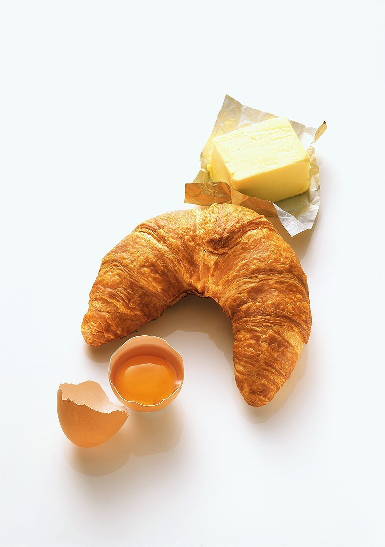 Croissant, butter and an egg 