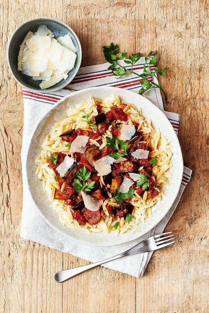 Chorizo with roasted eggplant on orzo