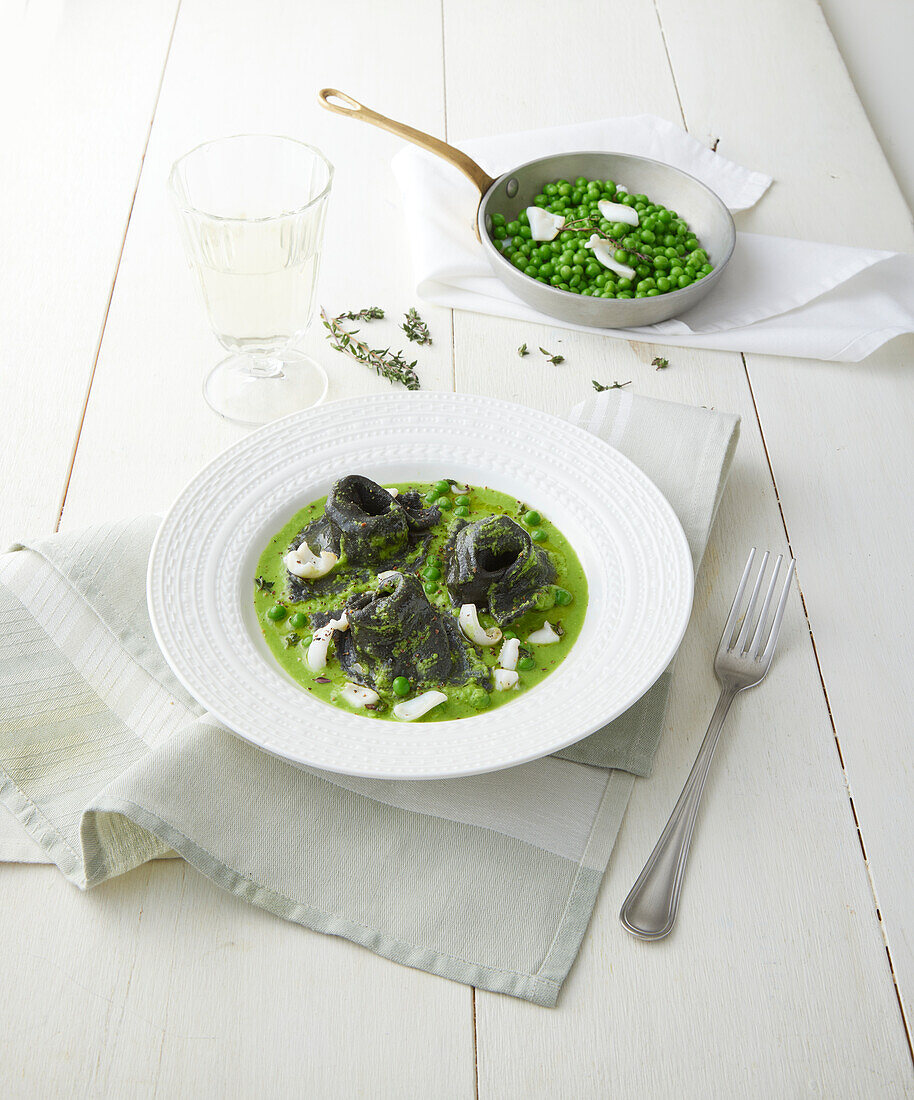 Black squid ink tortellini in pea sauce