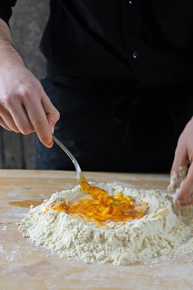 Making pasta dough: Mixing the egg with the flour
