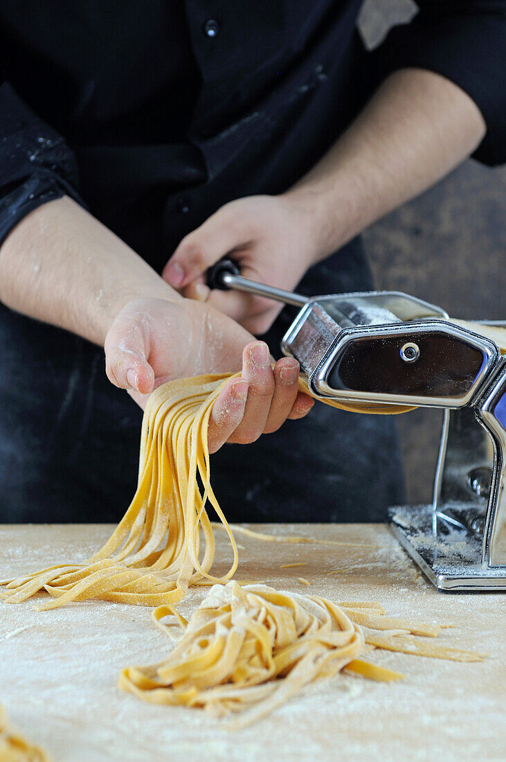 Cutting the tagliatelle with the pasta machine