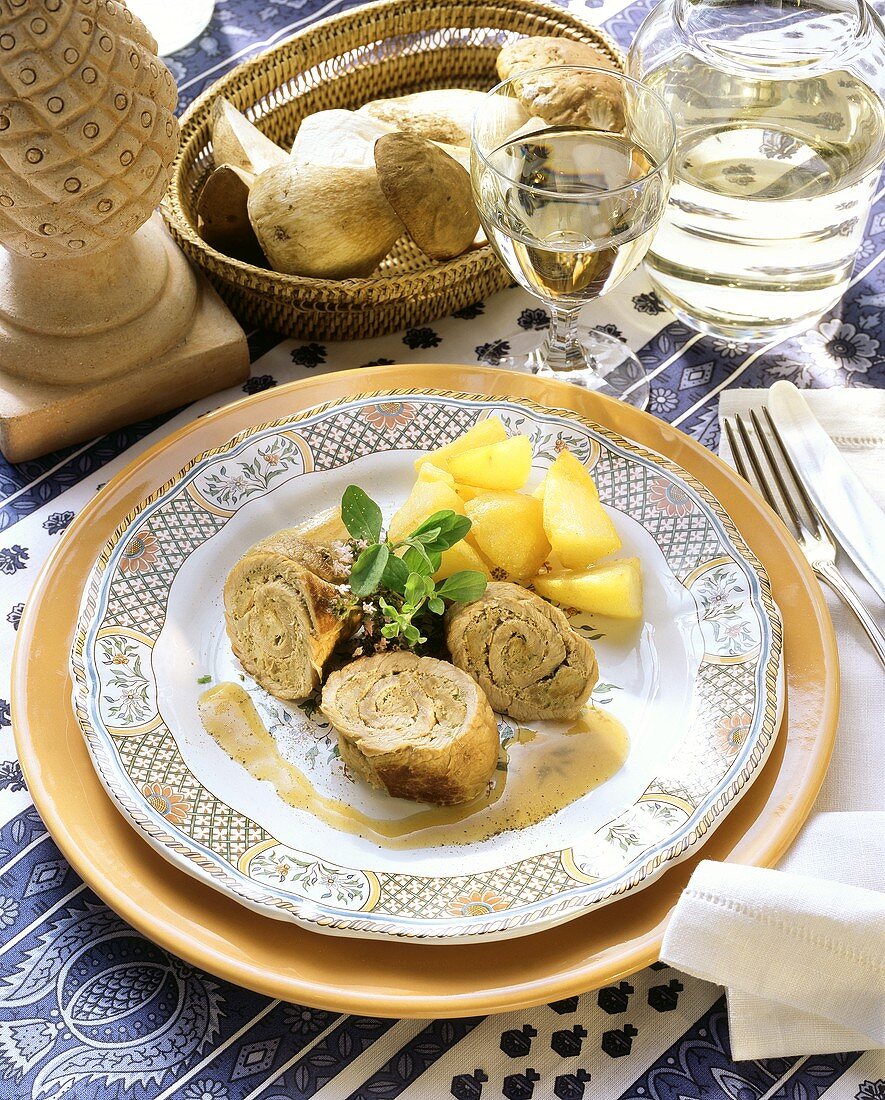 Veal roulades with cep stuffing and potatoes on plate